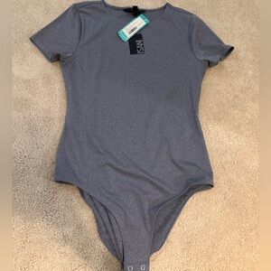 Isani woman’s body suit, short sleeve, medium light purple NWT